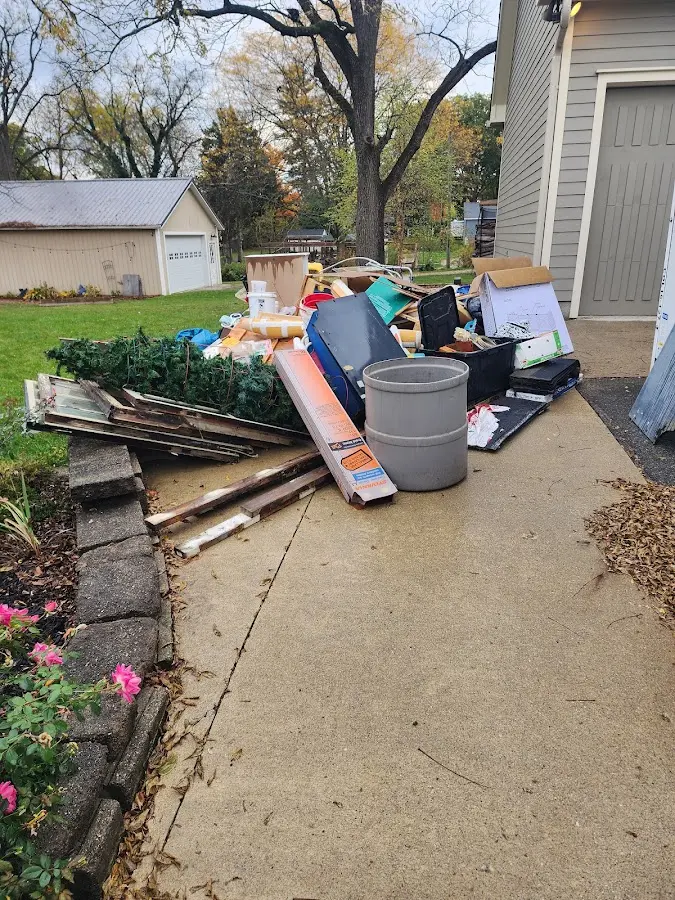 Dumpster being loaded with debris for Commercial Dumpster Rental in Tuttle